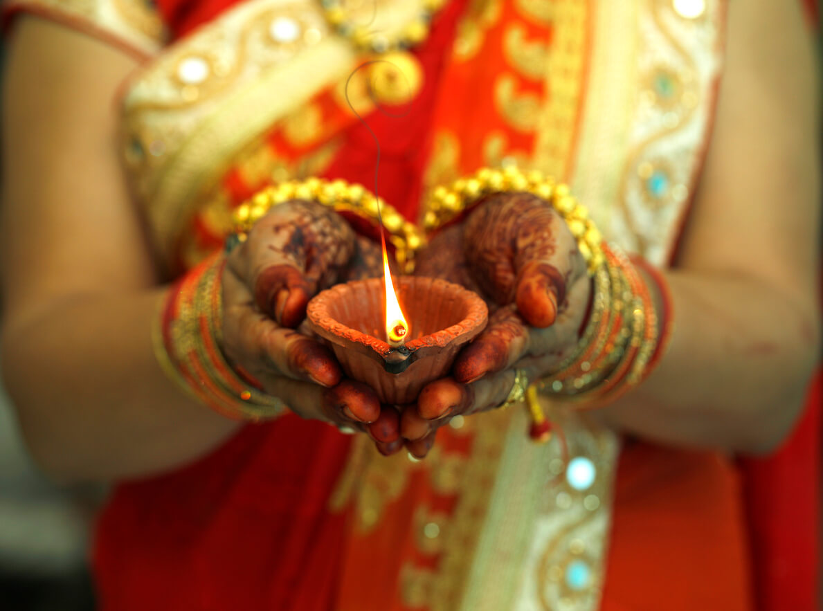 Indian woman holding Diwali oil lamp