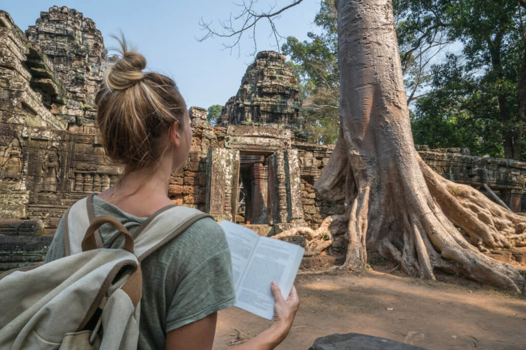 A student reading textbook outside the temple